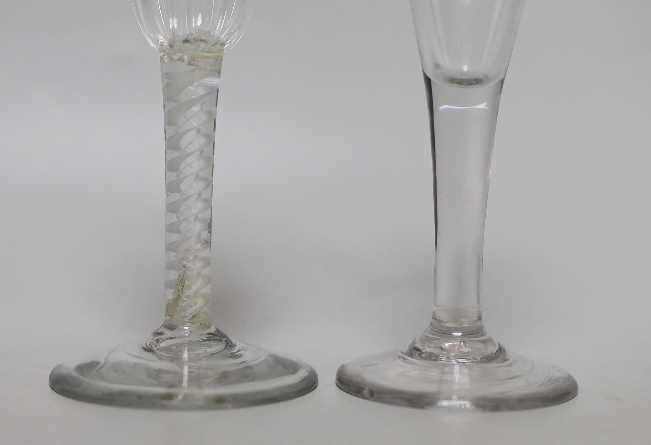 Two Georgian glasses including one with a double series opaque twist stem, the largest 15cm high